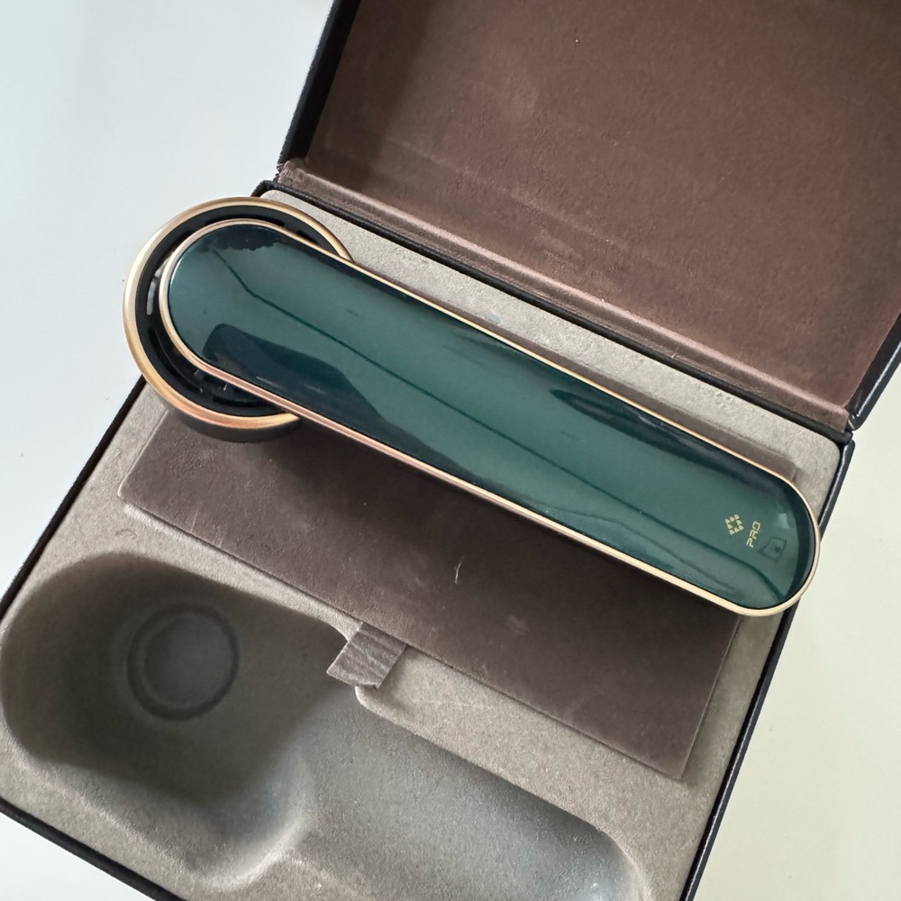 Elegant Green Skincare Tool with Gold Accents